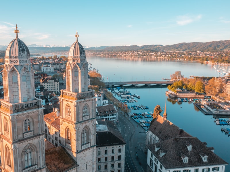 Zurich from above showing Limmat River and mountains in the distance
