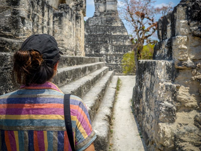 A girl walking Mayan ruins.
