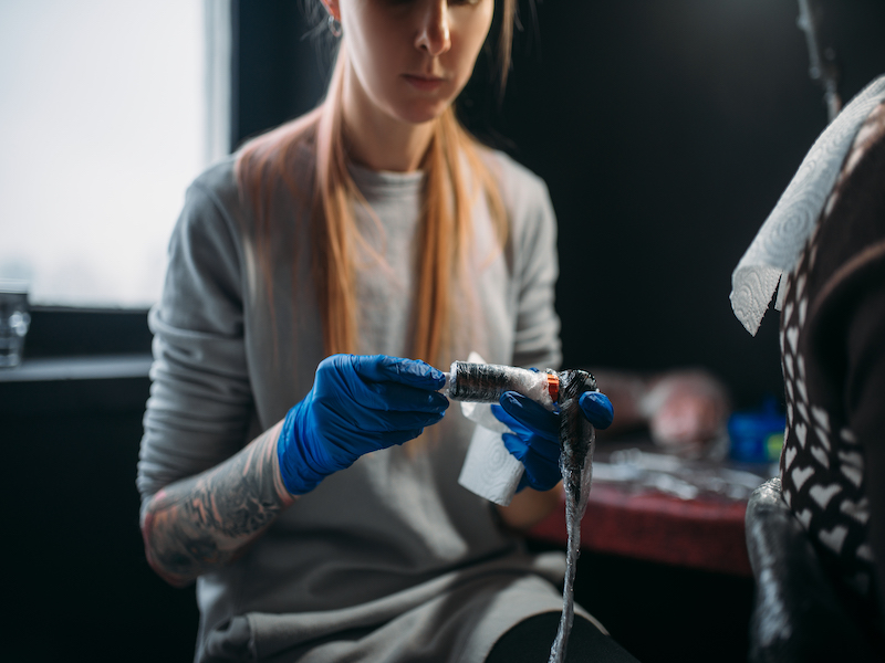 female artist in tattoo studio