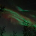 Ii: Snowmobile sleigh trip on frozen sea under starlit sky - A Deep Dive into the Arctic Adventure