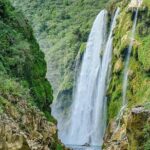 Tamul waterfall and water cave on a wooden canoe - What the Experience Means for Travelers